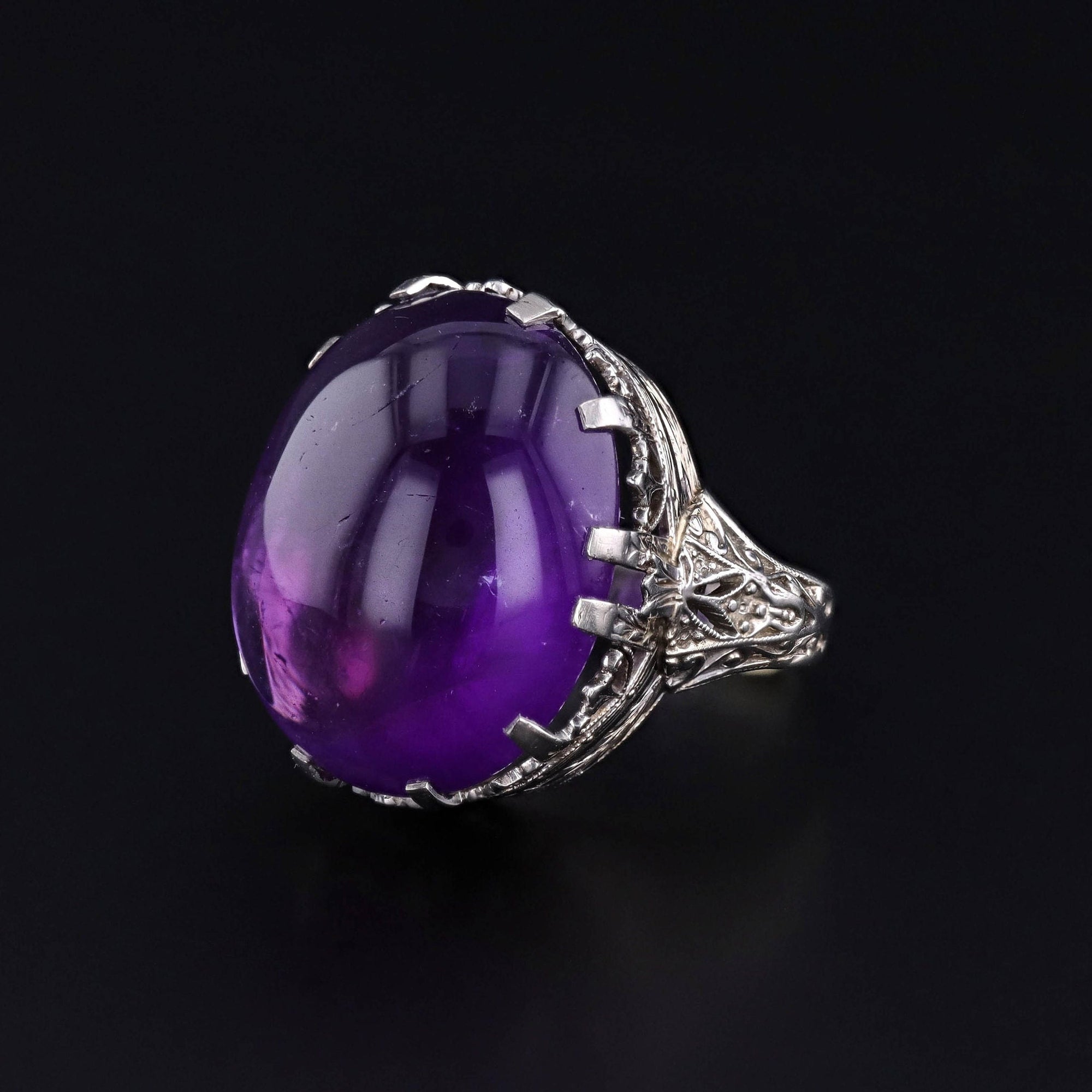 A vintage Art Deco Amethyst statement ring of 18k white gold. The ring dates to the 1920s and packs quite a punch of purple color.