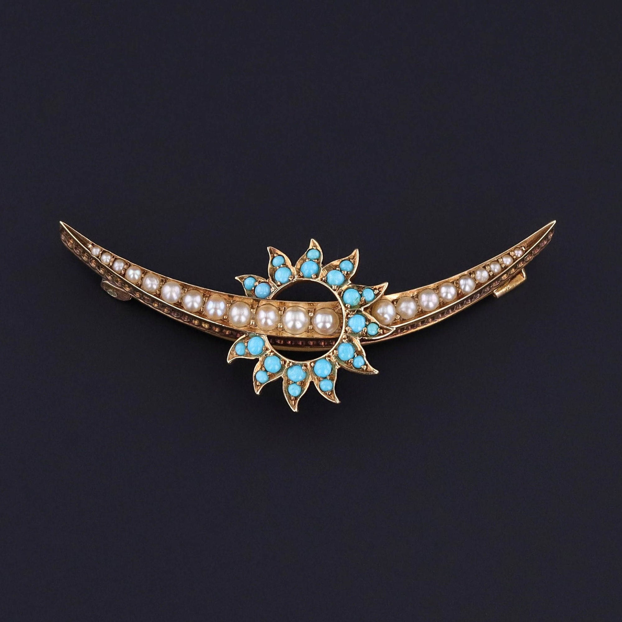 Antique Crescent Moon Brooch:&nbsp; This eye catching brooch features a pearl crescent inside of a turquoise sunburst. The piece is 14k gold and dates to the turn of the 20th century (circa 1890-1910).