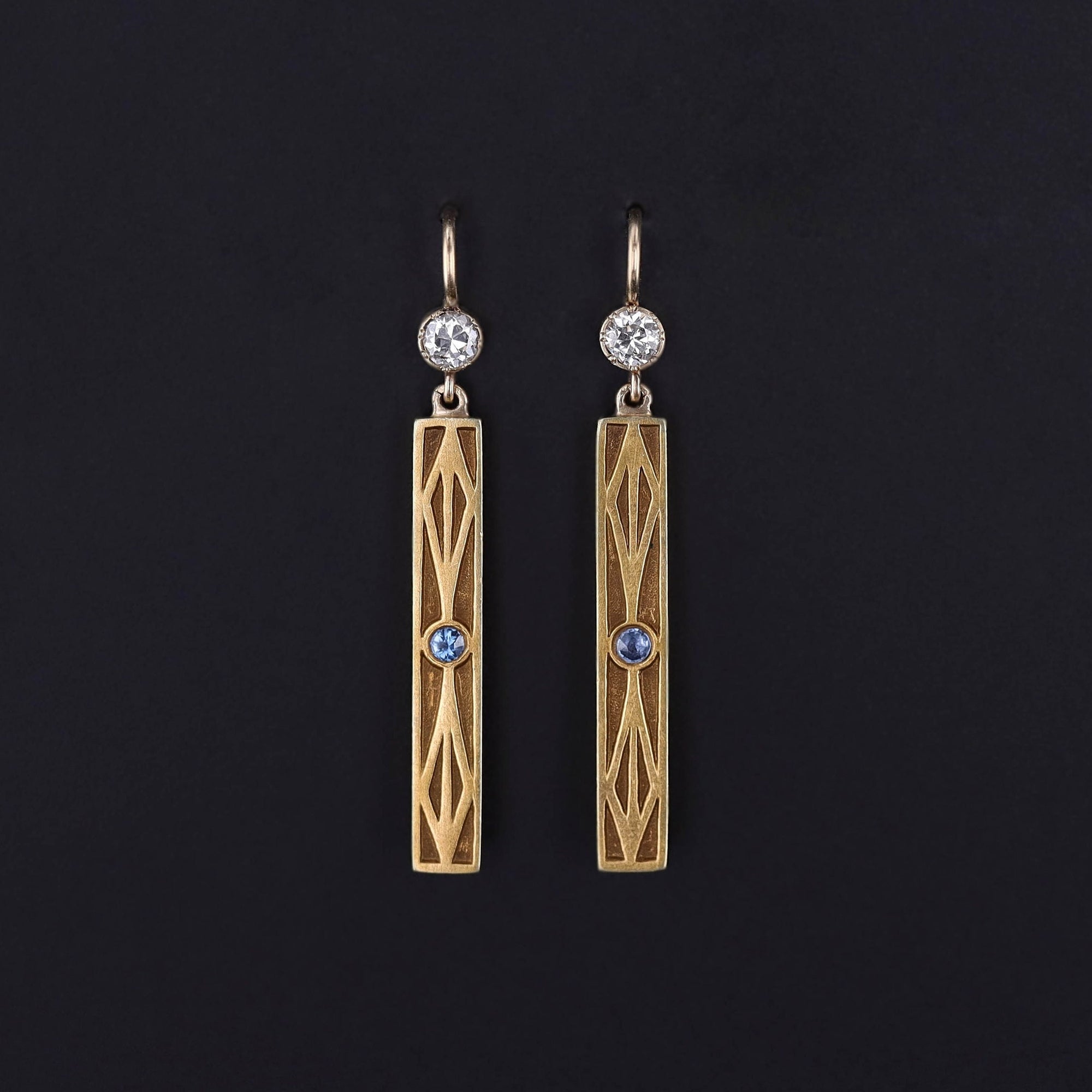 Antique Sapphire Earrings: Upcycled earrings created from antique bar pins dating to the turn of the 20th century (circa 1910). The rectangular 14k gold drops are adorned with sapphires and accented with diamond surmounts.
