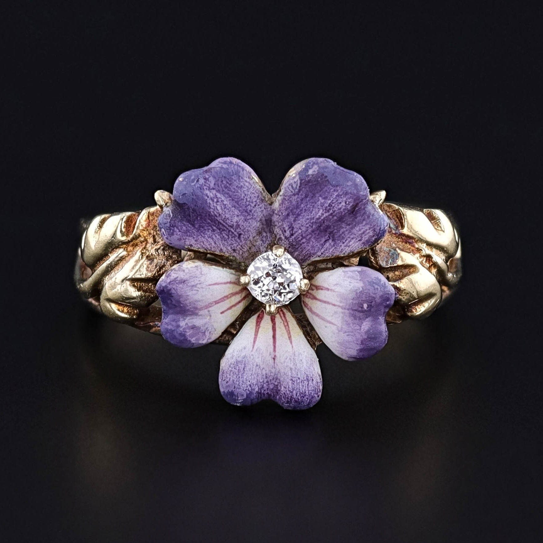 An antique 14k gold enamel and diamond pansy flower ring from the 1920s. The ring is perfect for any jewelry collector, lover of flowers, or gardener.