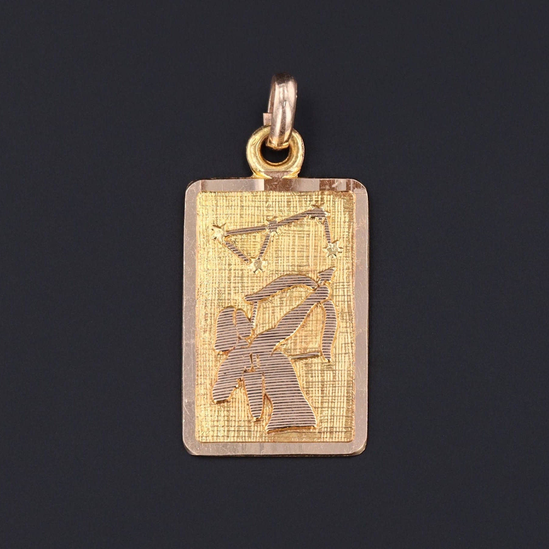 sagittarius zodiac pendant depicting an archer of gold