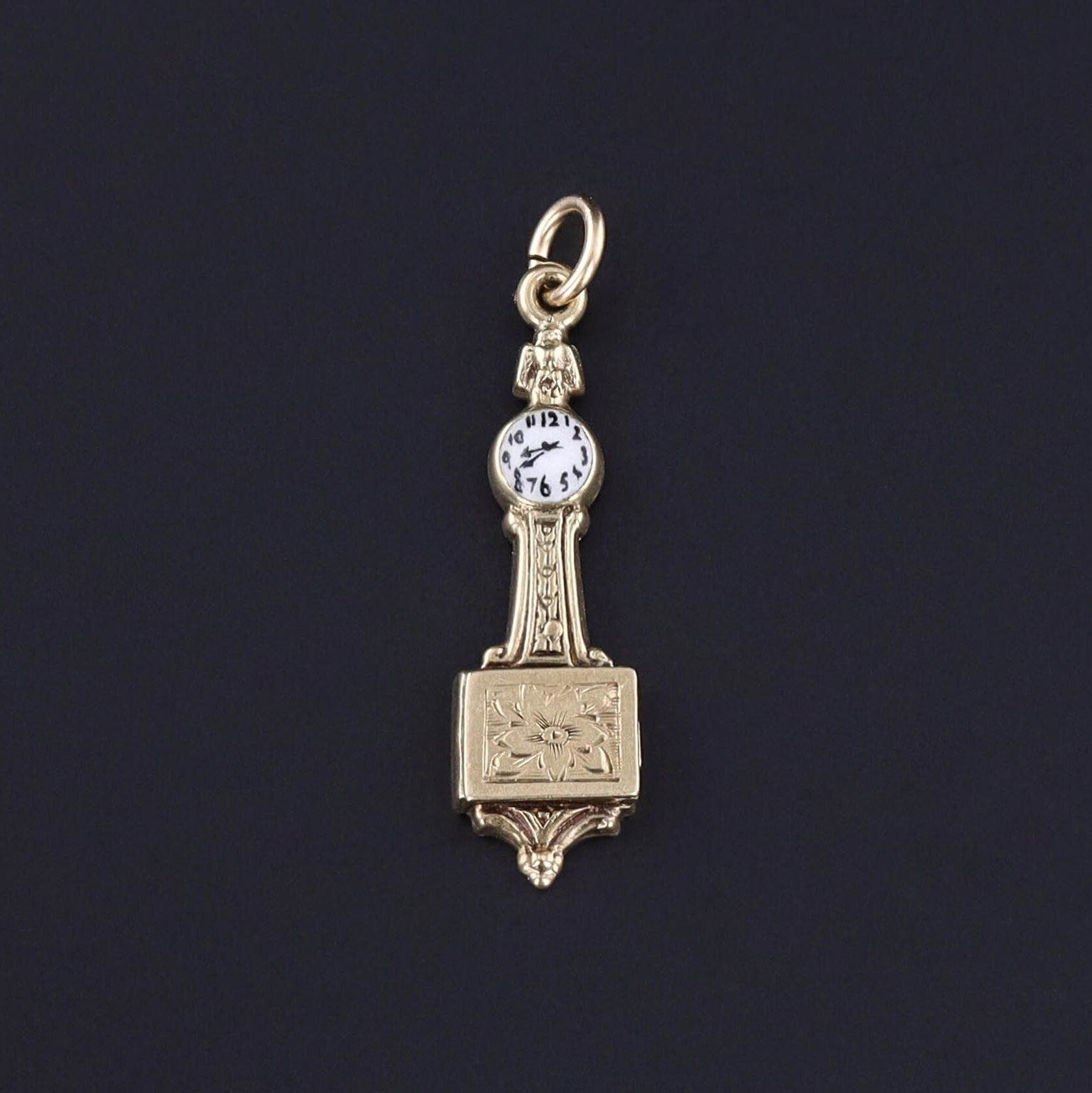 Vintage Grandfather Clock Charm: Explore the vintage allure of this well rendered charm by Sloan & Co. (circa 1930-1940). The charm depicts a grandfather clock with a face of pristine white enamel, and a hand etched floral design.