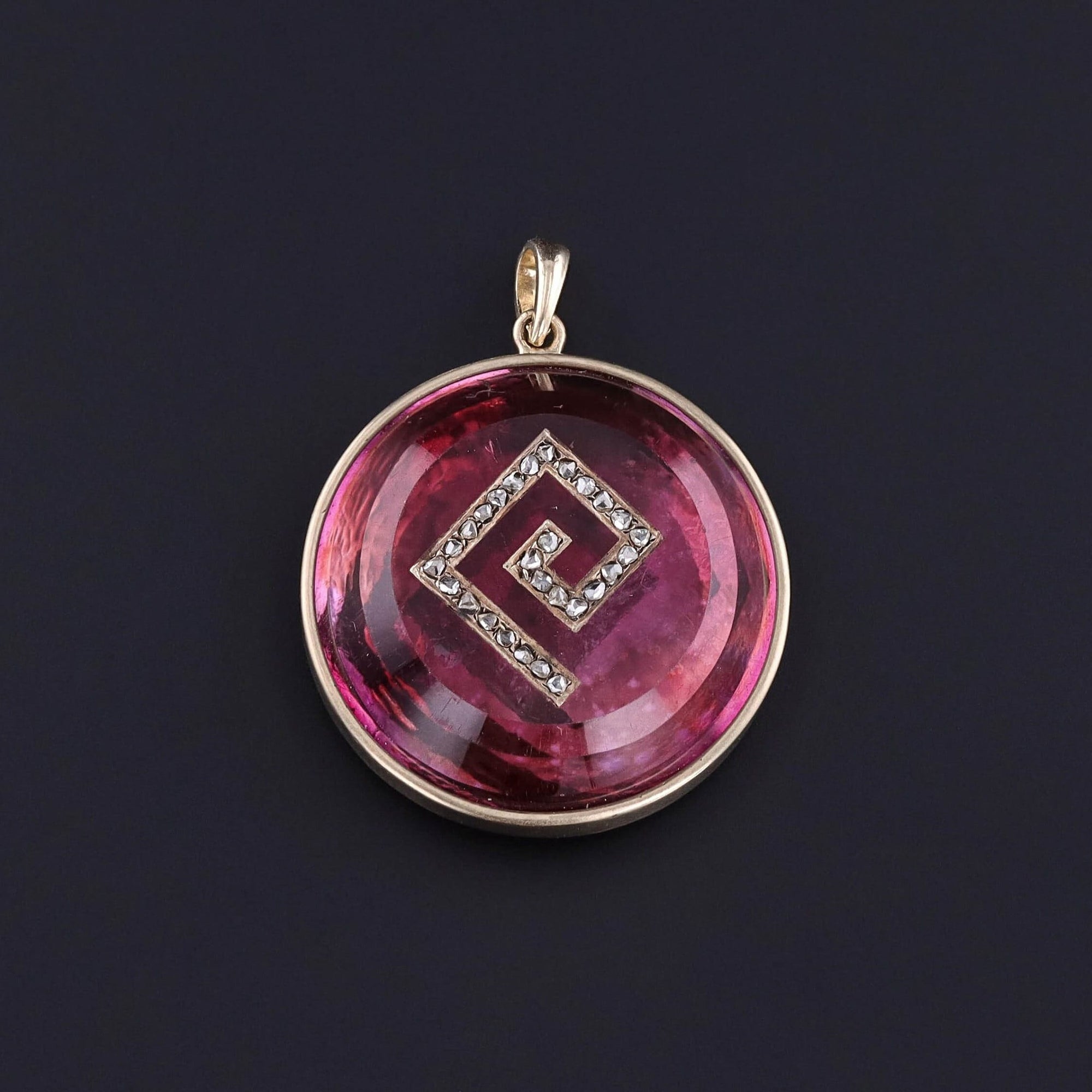 Antique Pink Rock Crystal & Diamond Pendant: Step into the past with this captivating antique 14k gold pendant showcasing a pink foil-backed rock crystal inlaid with a Greek key motif. The Greek key is adorned with rose cut diamonds.
