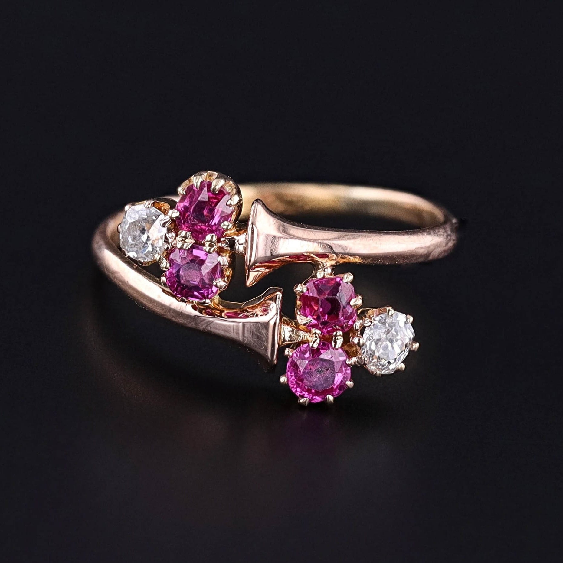 Antique Ruby and Diamond Crossover Ring from the late Victorian era showcasing two ruby and diamond trefoils set in 18k rose gold. A perfect ring for any antique jewelry collector or anyone with a love of fine jewelry.
