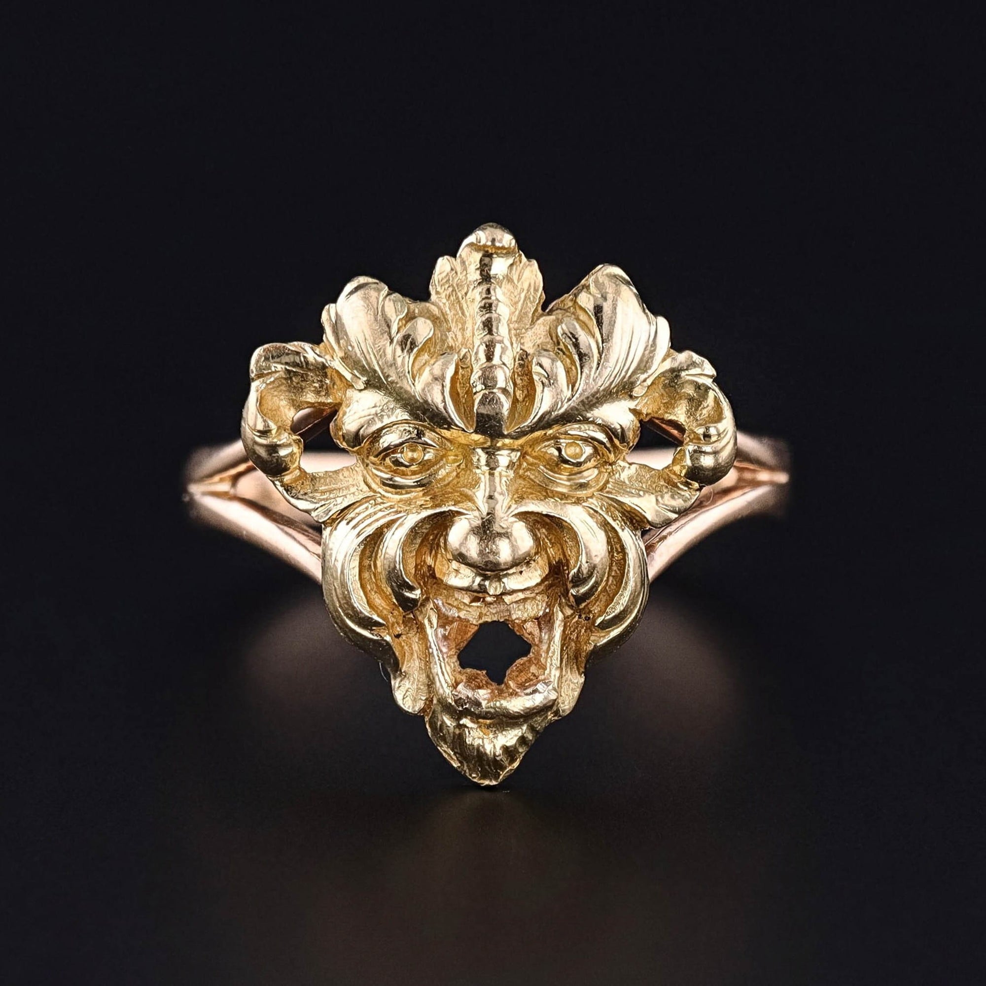 An antique figural ring depicting a greenman or a gargoyle of 14k gold.