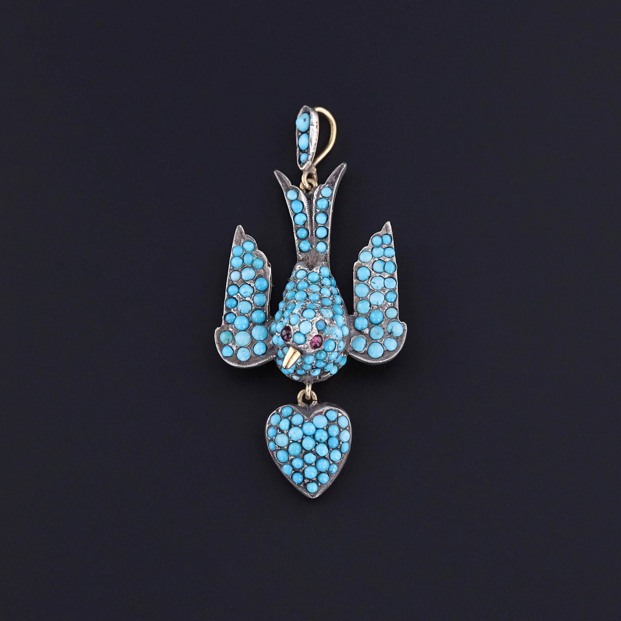 A Victorian era swallow pendant featuring pave set turquoise. The piece is in excellent condition and silver topped 18k gold.