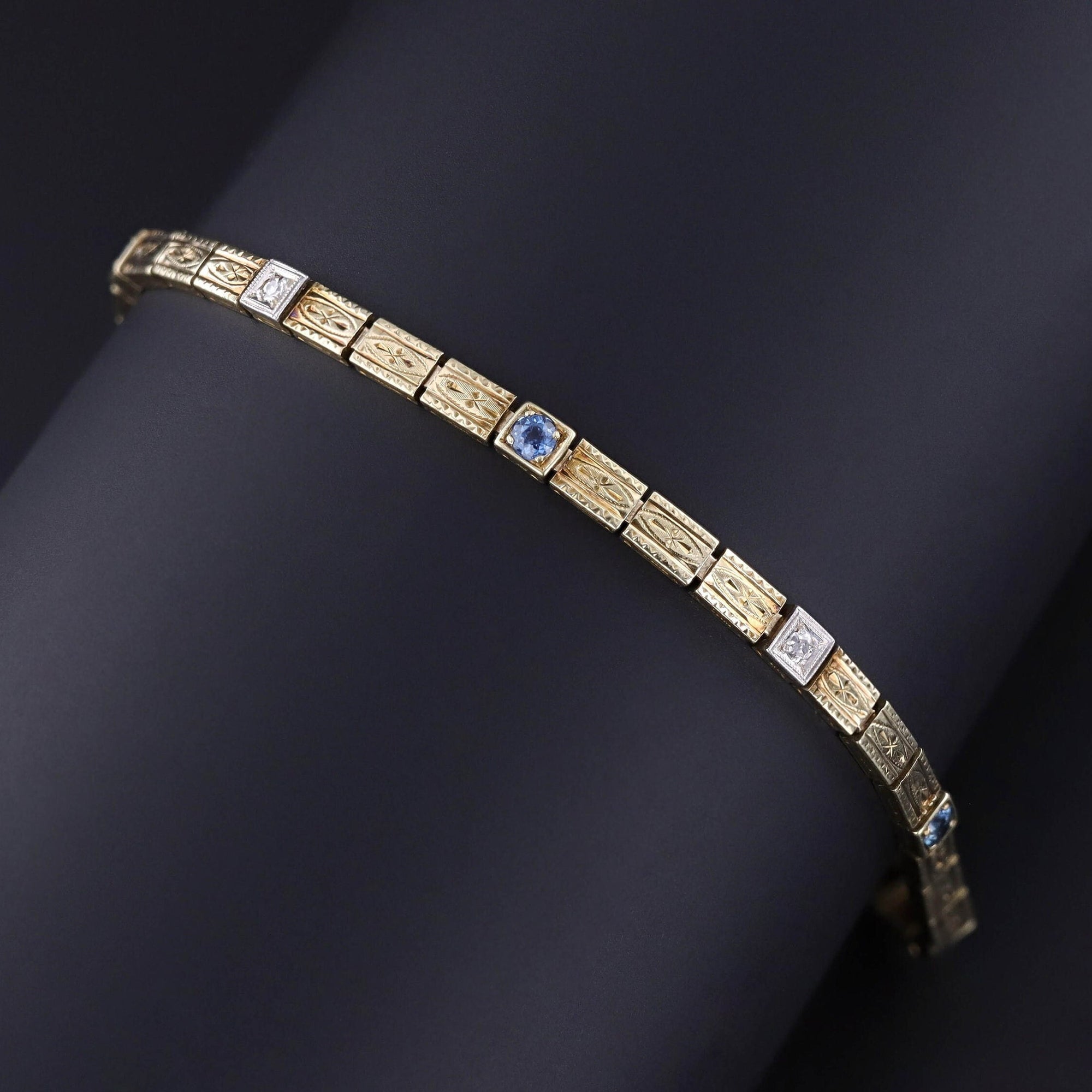 An Art Deco sapphire and diamond line bracelet adorned with sapphires and old European cut diamonds. The bracelet measures 7.8 inches and is in excellent condition.