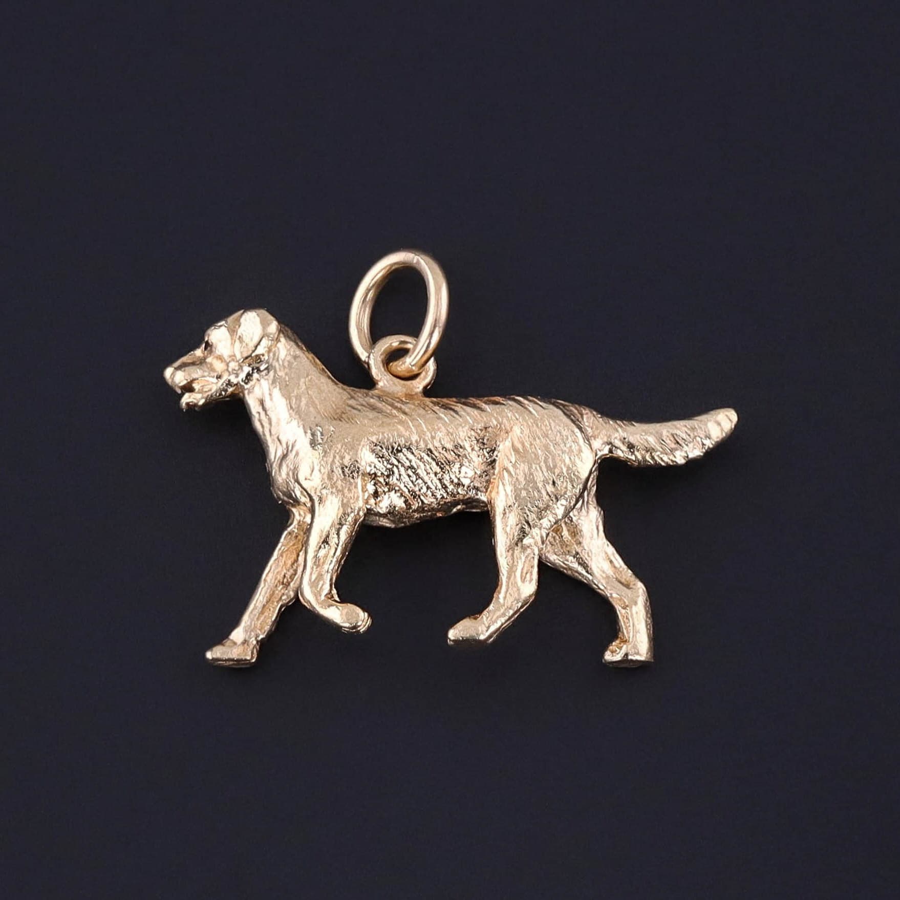 Vintage Golden Retriever Charm: This vintage charm (circa 1950-1970) features a dog crafted of solid 14k gold. The charm measures 0.8 inches from the top of the bail to bottom by 1 inch wide and weighs 6.02 grams. It is in great condition.