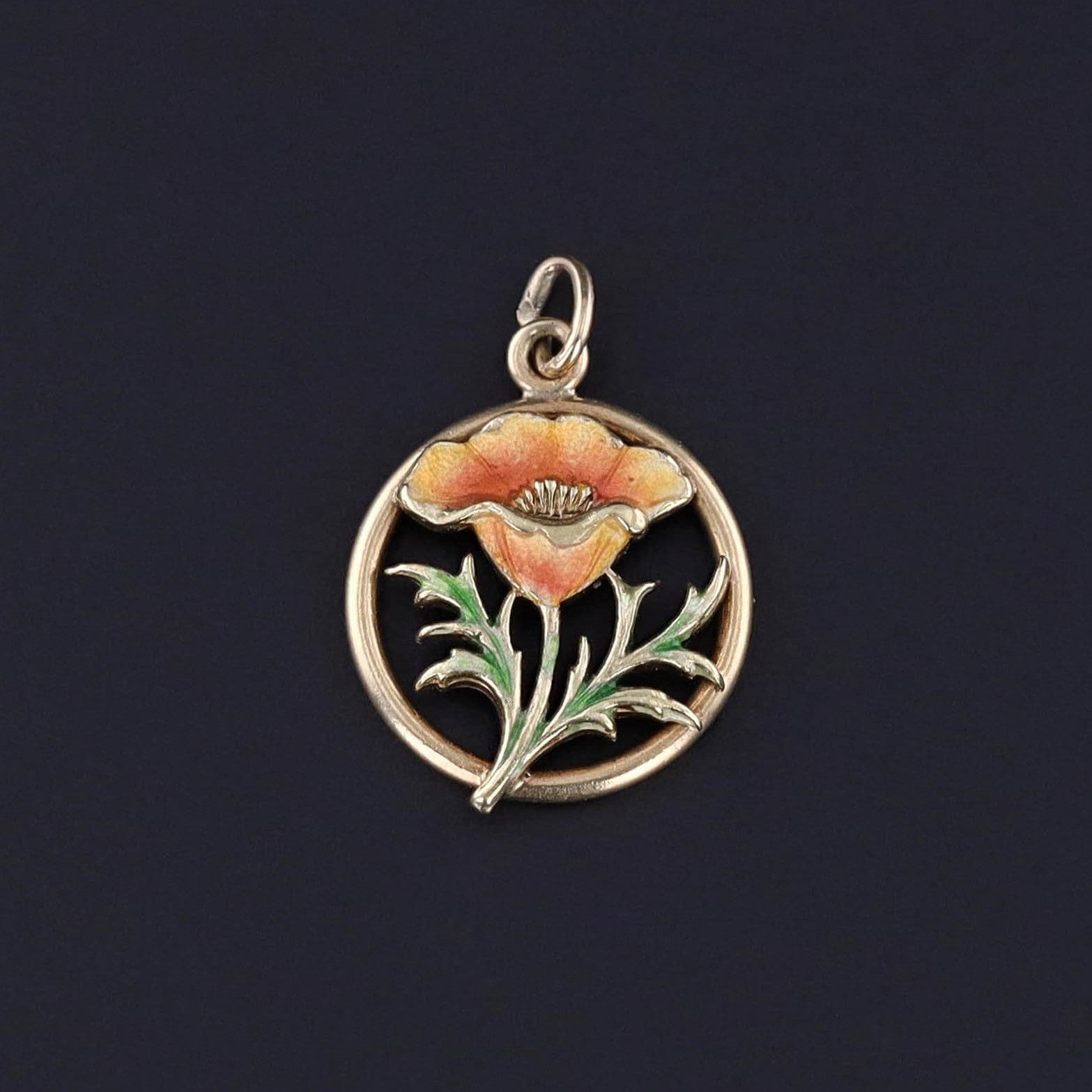 An antique enamel poppy flower charm of 14k gold. The piece would be perfect worn on a gold chain, charm bracelet, or charm necklace. It would also be a great gift for anyone who lives poppies or anyone named Poppy.