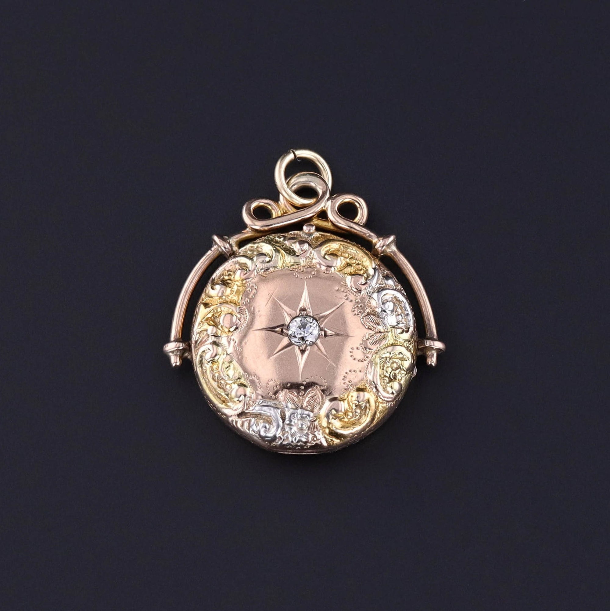 A 10k rose gold locket adorned with a diamond star and accented with yellow gold and platinum. A perfect gift for any antique jewelry lover or anyone looking for a special keepsake.