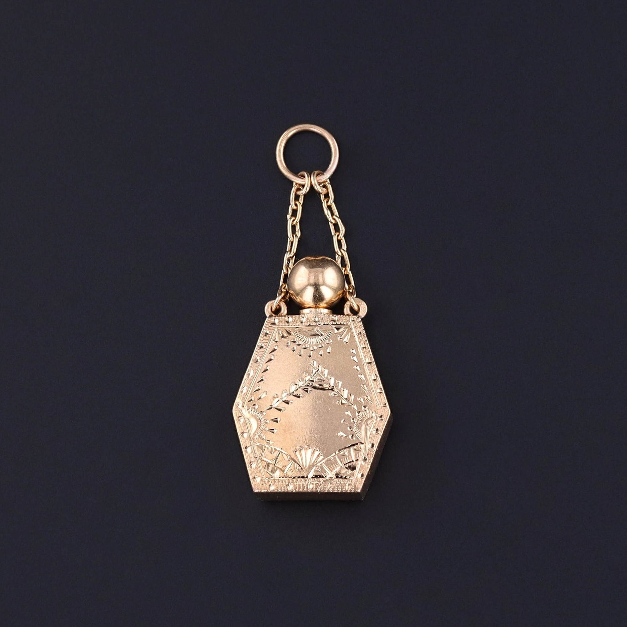 An Antique Perfume Charm: This antique charm (circa 1900-1910) features a hand etched perfume bottle of 18k gold. It has a stopper that comes out so you canadd your favorite scent to the bottle.
