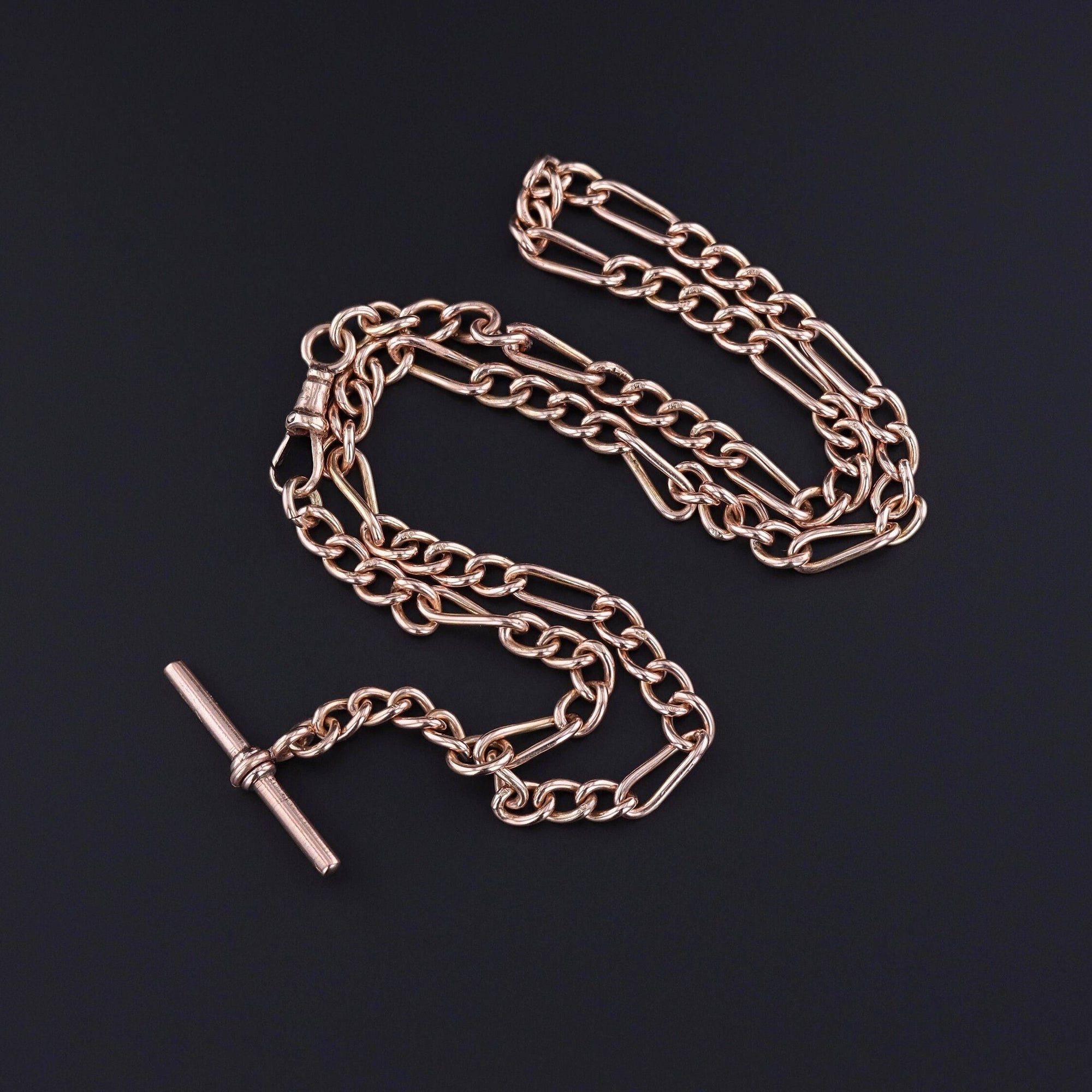 An antique gold watch chain from the early 1900s. The chain is 17 inches long with a T bar and additional 1 inch drop. It is stylish and perfect for any jewelry lover.