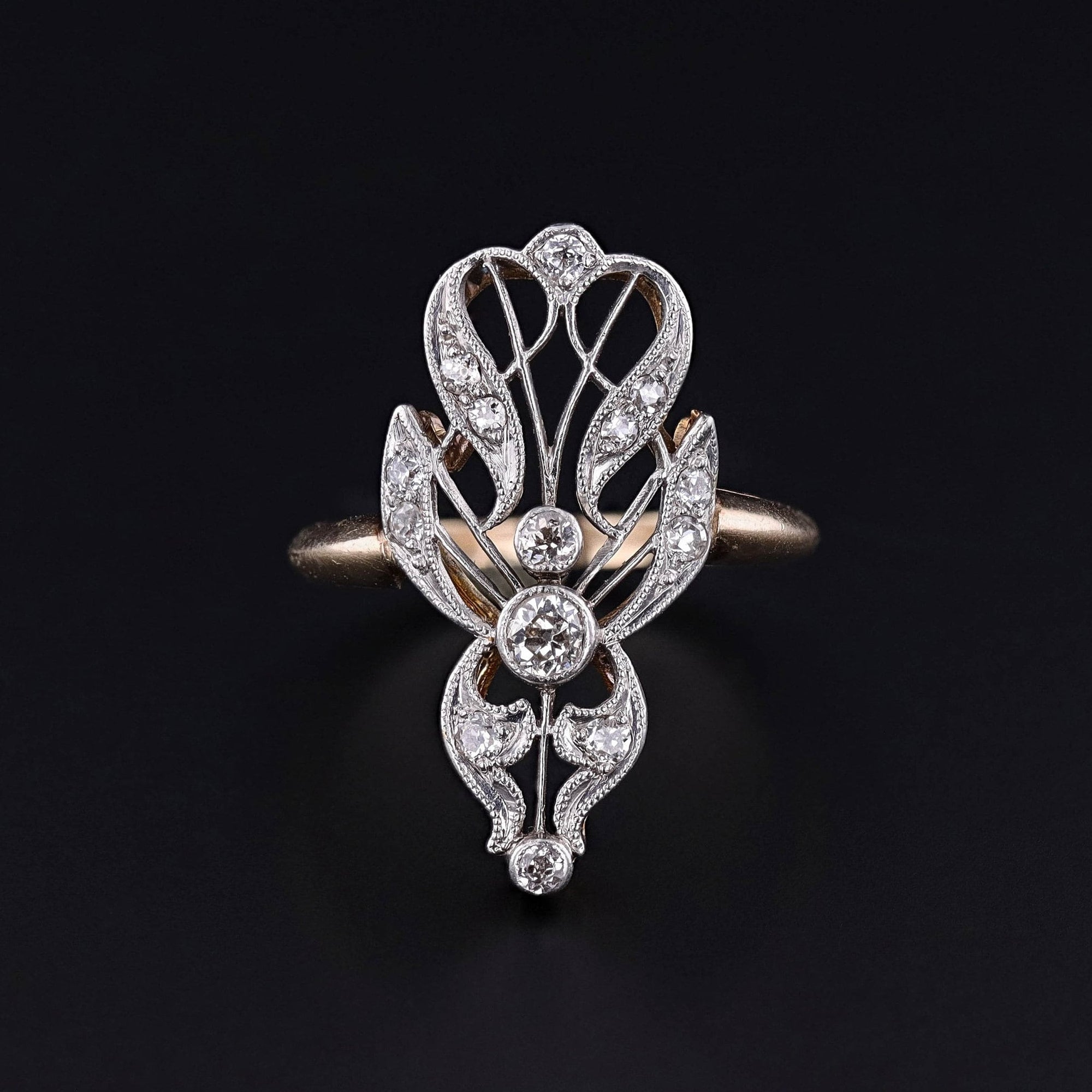 A belle epoque era platinum topped 14k gold diamond ring. The elongated ring is in excellent condition and currently a large size 9.25. It can be re-sized free of charge.