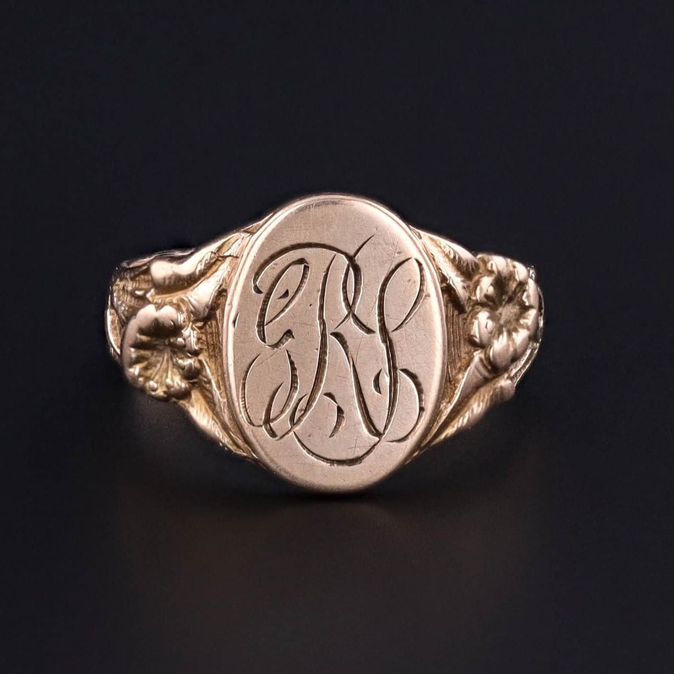 Antique Signet Ring: Step into the elegance of the early 20th century with this antique signet (circa 1900) featuring the initials &#39;GRY&#39; engraved on the face. The 10k gold ring has an elegant floral design on the shoulders.