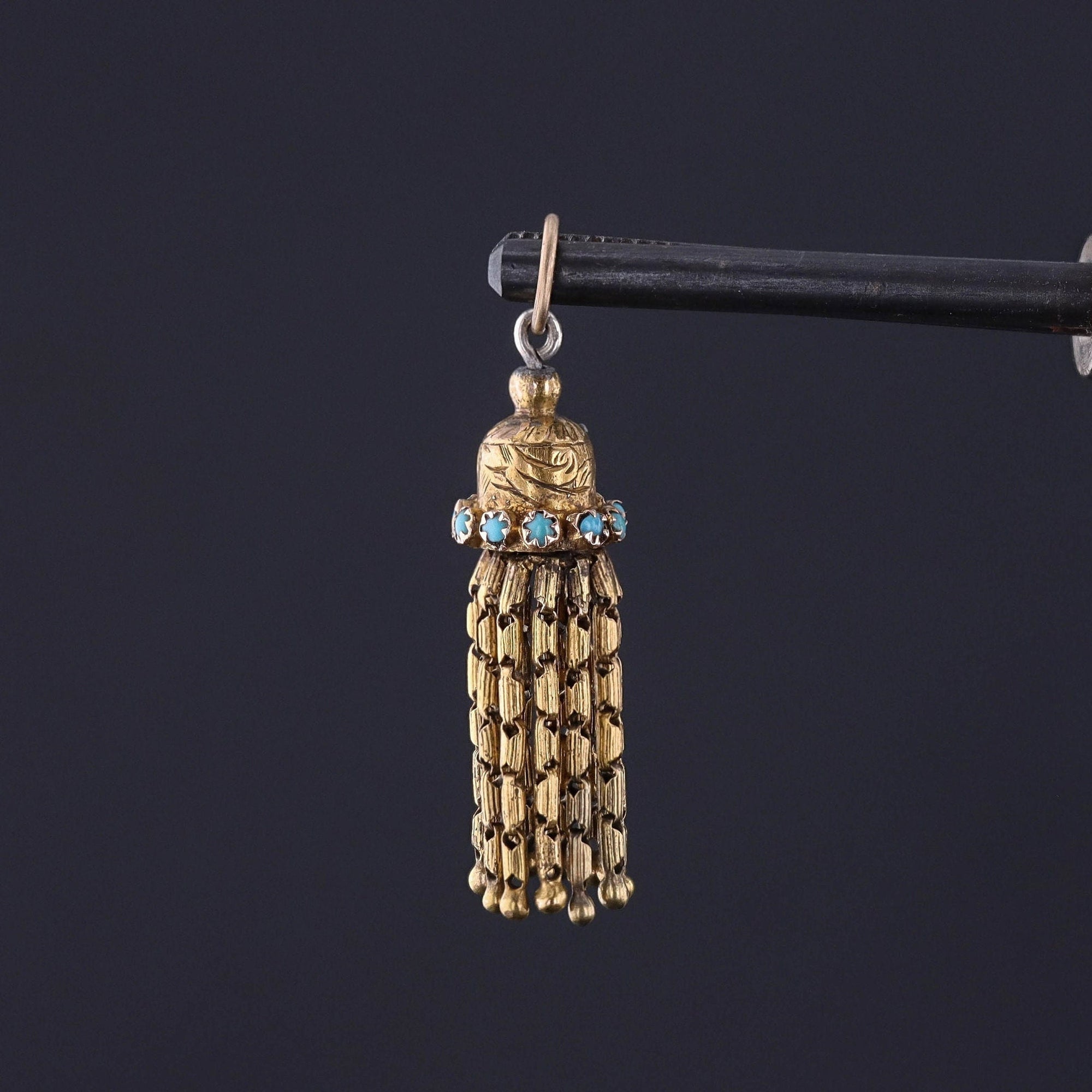 An 18k gold pendant from the Victorian era. The tassel pendant is adorned with turquoise glass cabochons and it is in great condition. Perfect for anytime wear or for a Victorian jewelry collector.