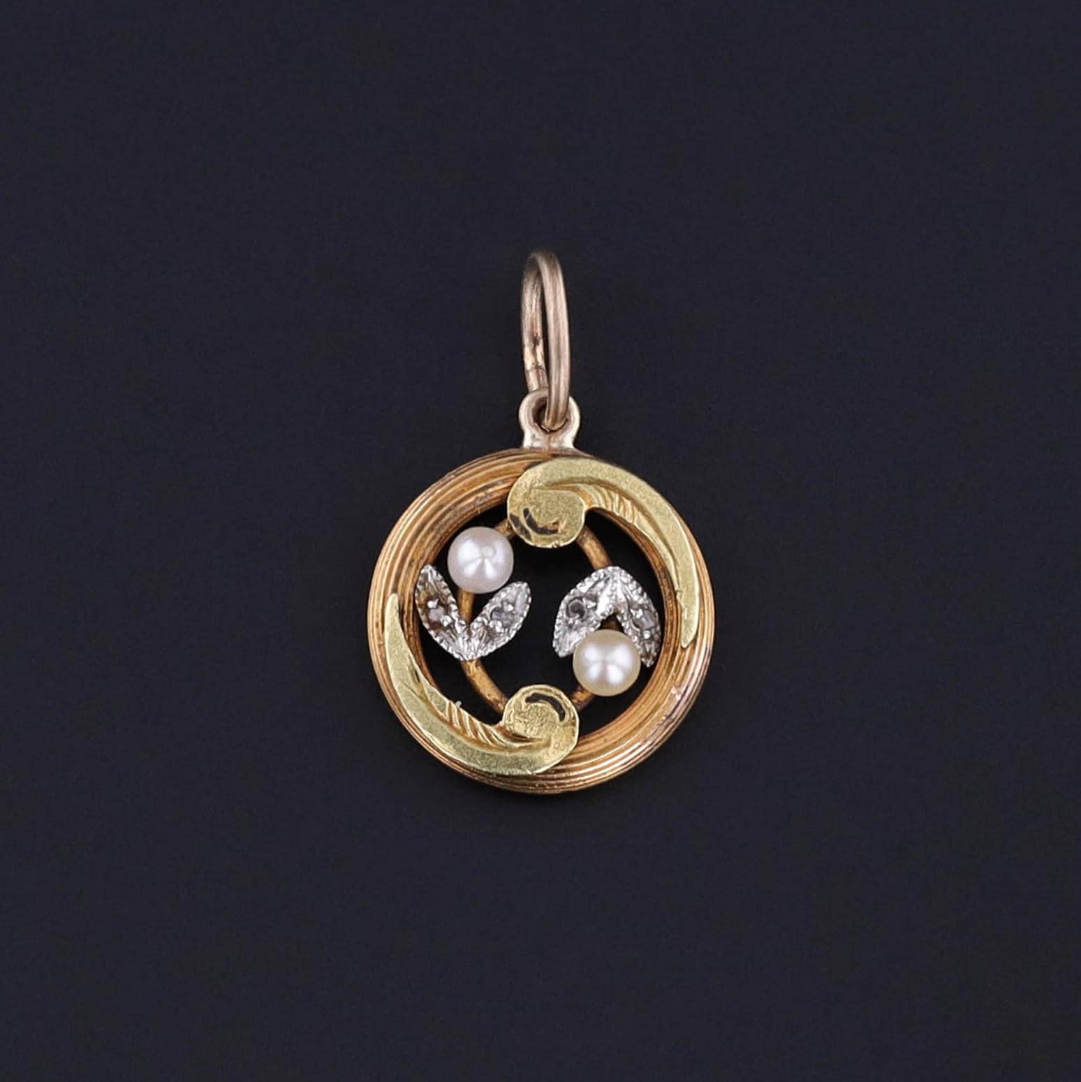 Add a pop of old world style to any ensemble with this petite floral charm featuring rose cut diamonds and pearls. Originally an 18k gold stickpin from the turn of the 20th century, our skilled jeweler transformed it by adding a bail.