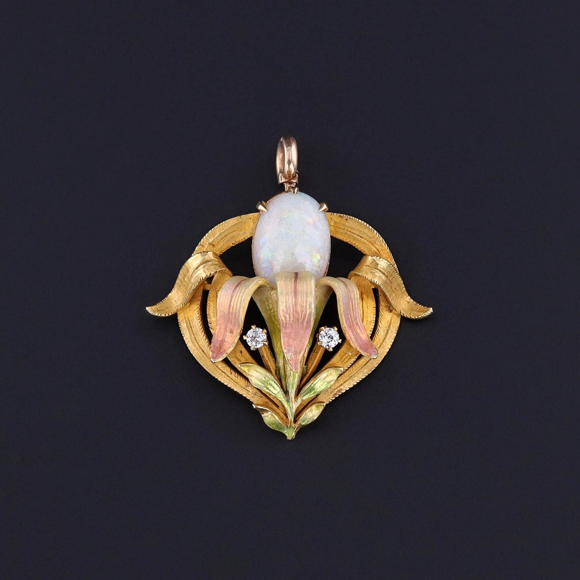 Antique Opal Flower Pendant: Step into the elegance of the early 20th century with this Art Nouveau era jewel featuring a graceful opal iris adorned with pink and green enamel and two sparkling diamond accents.