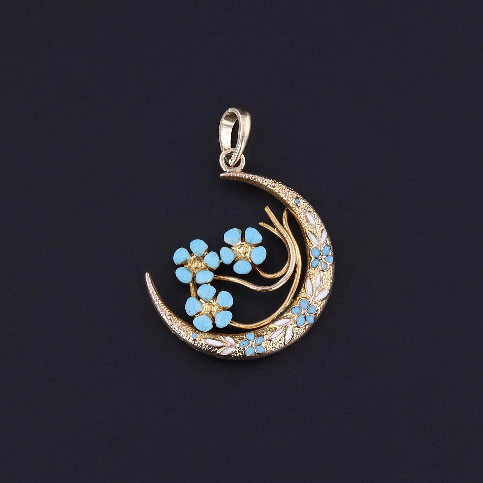 An antique enamel forget-me-not flower crescent moon pendant created from an antique pin. The 14k gold pendant is in great condition.