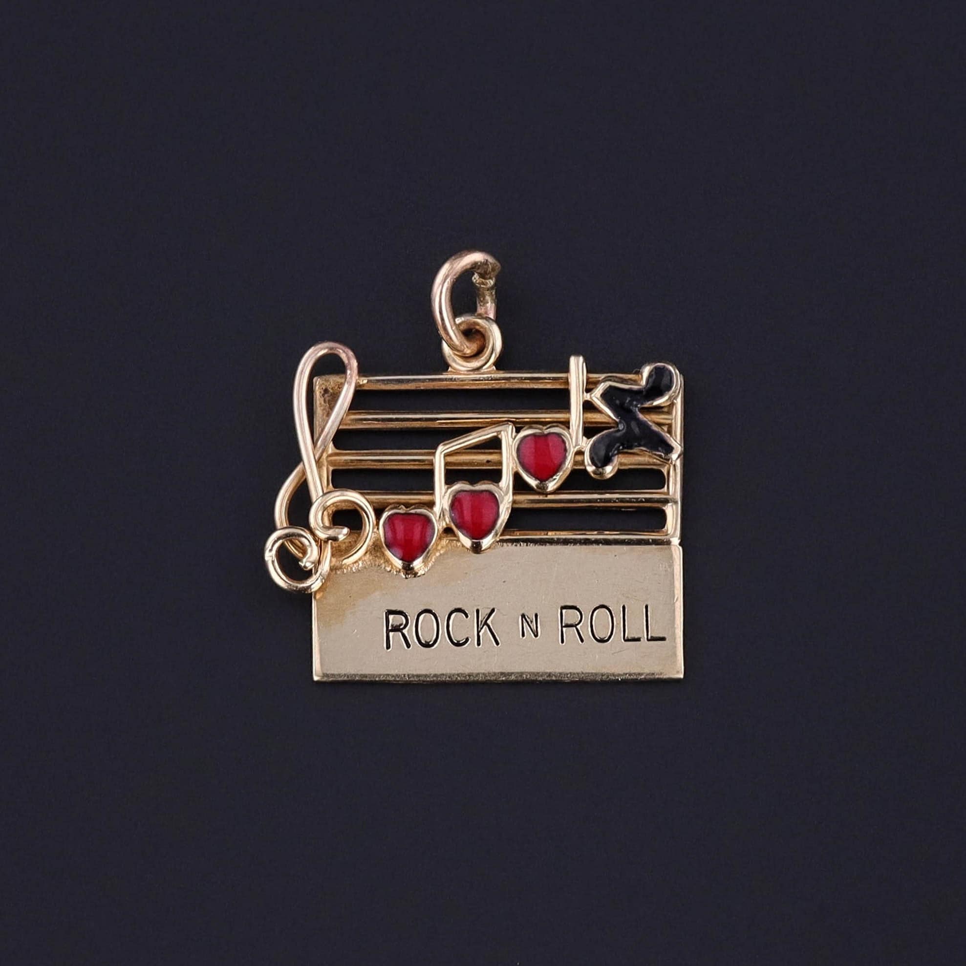 Vintage Rock N Roll Charm: Step into the mid-century with this vintage 1960s charm, featuring a music bar crafted from 14k gold adorned with heart-shaped notes in red and black enamel.