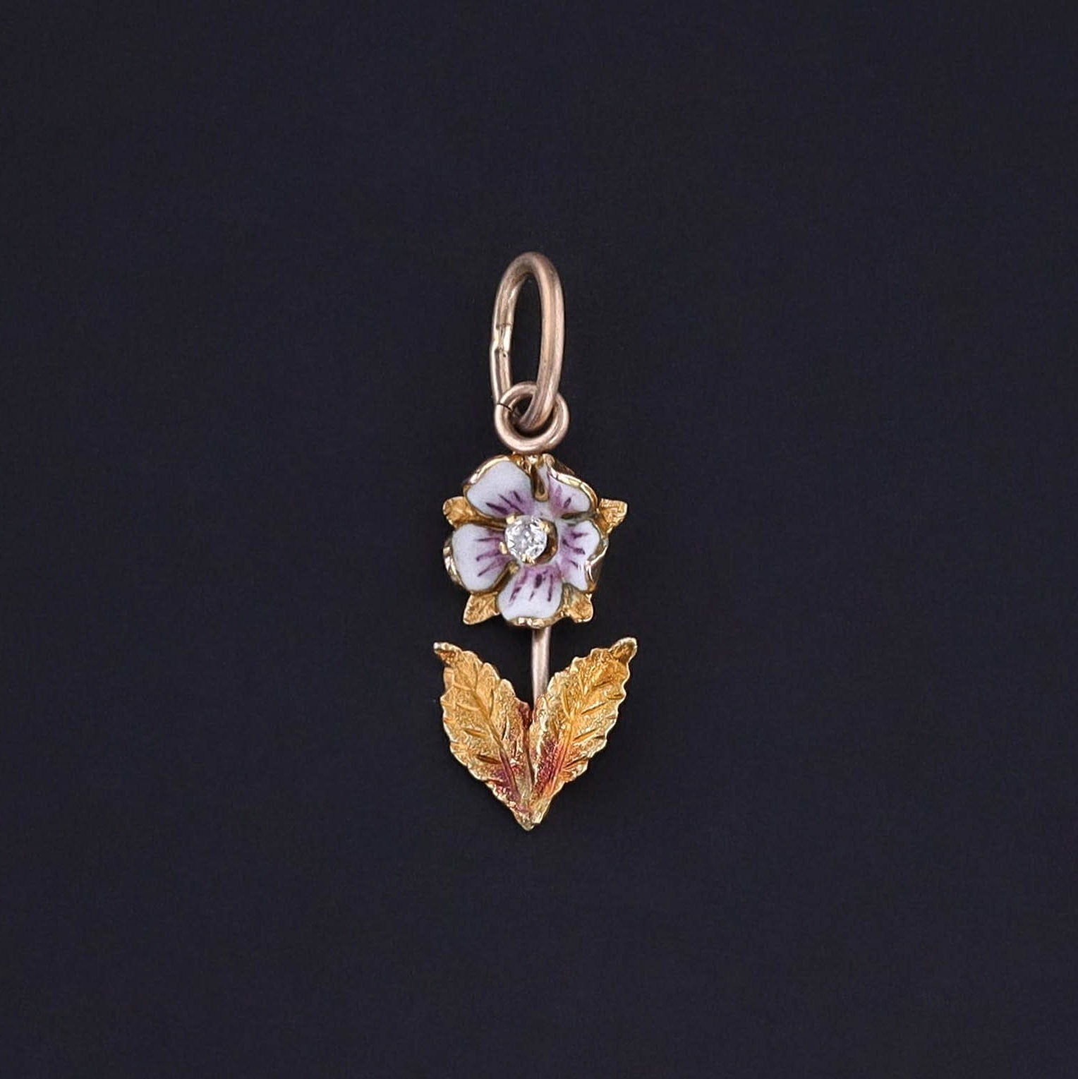 An antique purple enamel flower charm with golden leaves. The flower was originally part of an antique brooch circa 1900. It is in great condition. Perfect for any charm bracelet or charm necklace.