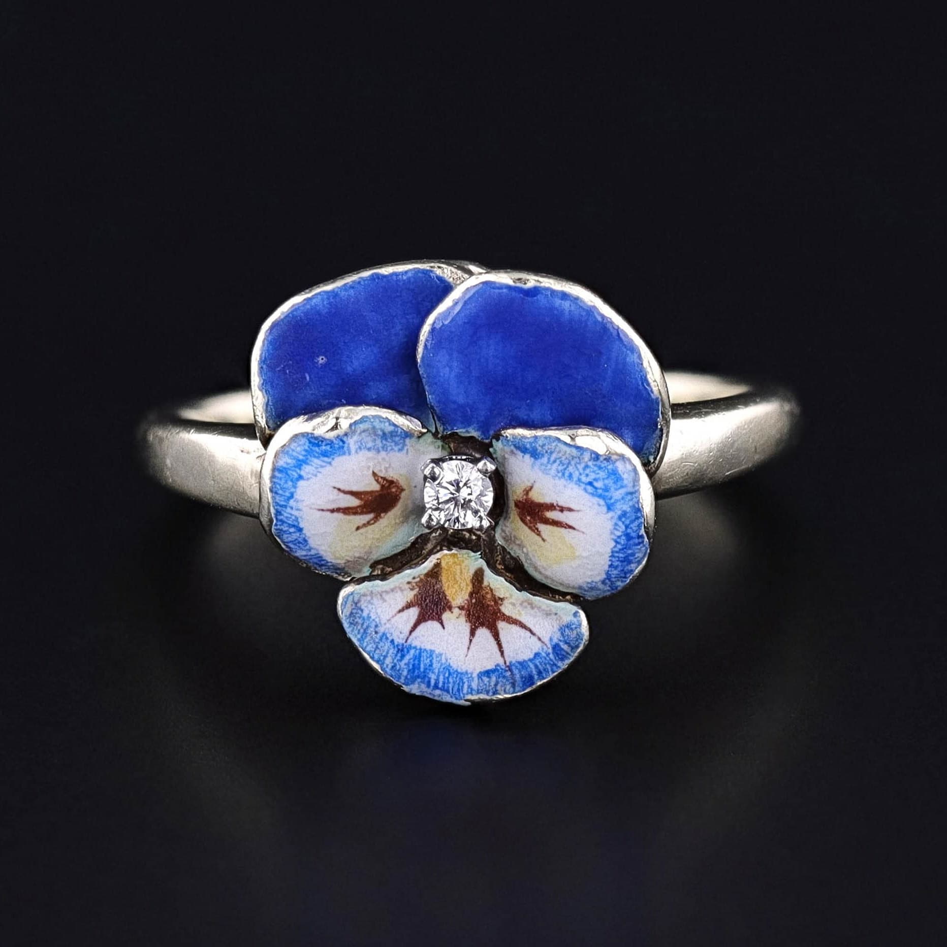 Vintage Pansy Ring: Step into the elegance of the early 20th century with this vintage blue enamel pansy ring by Larter & Co. The ring (circa 1920-1930) is crafted from 14k gold and features a sparkling diamond accent at it&#39;s center.