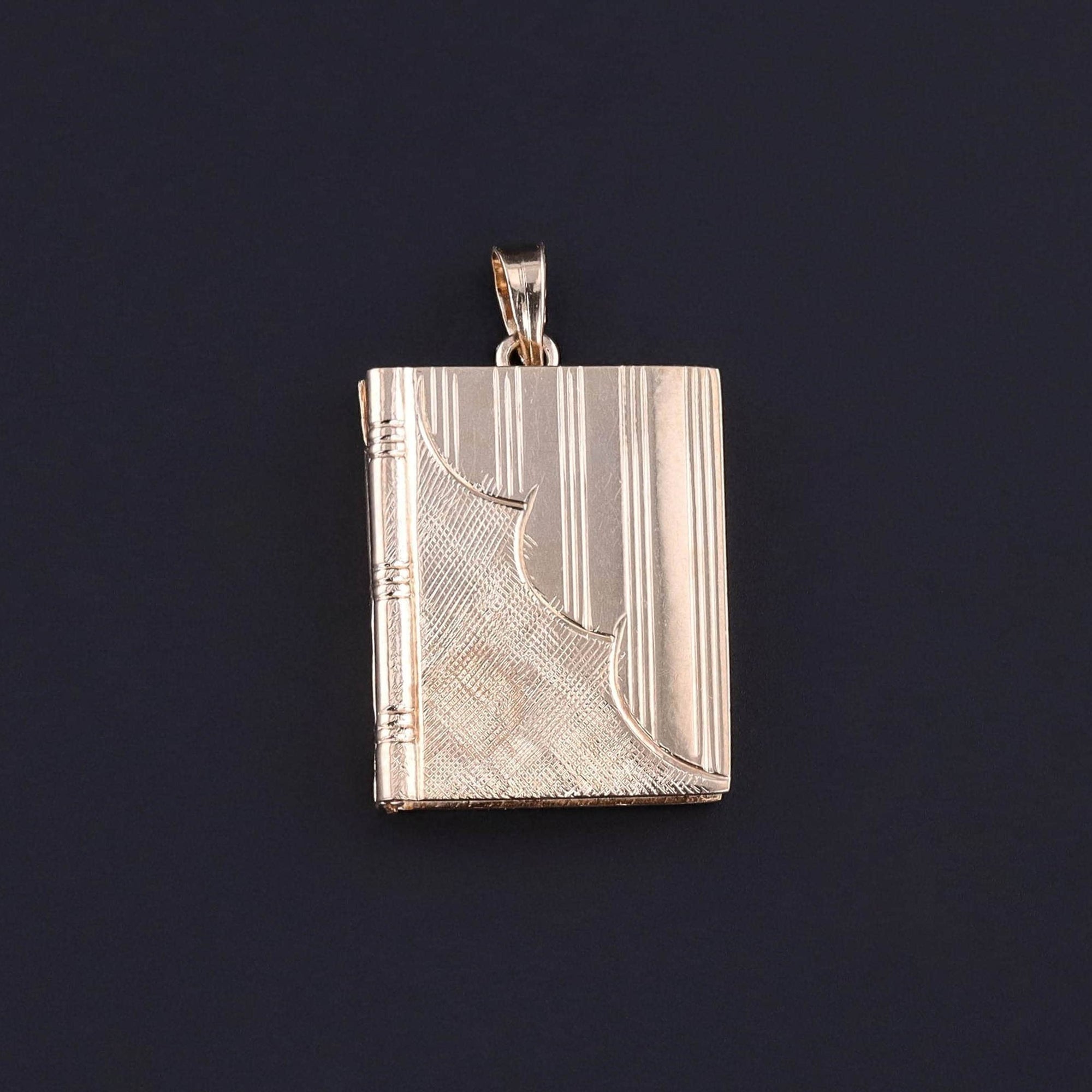 Vintage Book Locket Pendant: Embrace the nostalgia of the 1930s-1940s with this vintage locket, showcasing a hand-engraved book crafted from radiant 14k gold. Perfect for any jewelry collector or vintage jewelry lover.This would be a great keepsake.