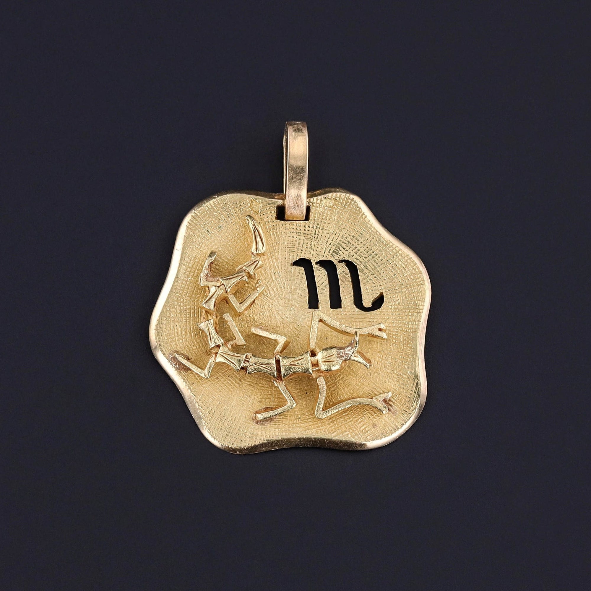 An 18k gold zodiac pendant for a Scorpio. The pendant features the symbol for the Scorpio zodiac sign and also a scorpion. The 3D piece is in great condition and solid gold. Perfect for any Scorpio or jewelry lover.