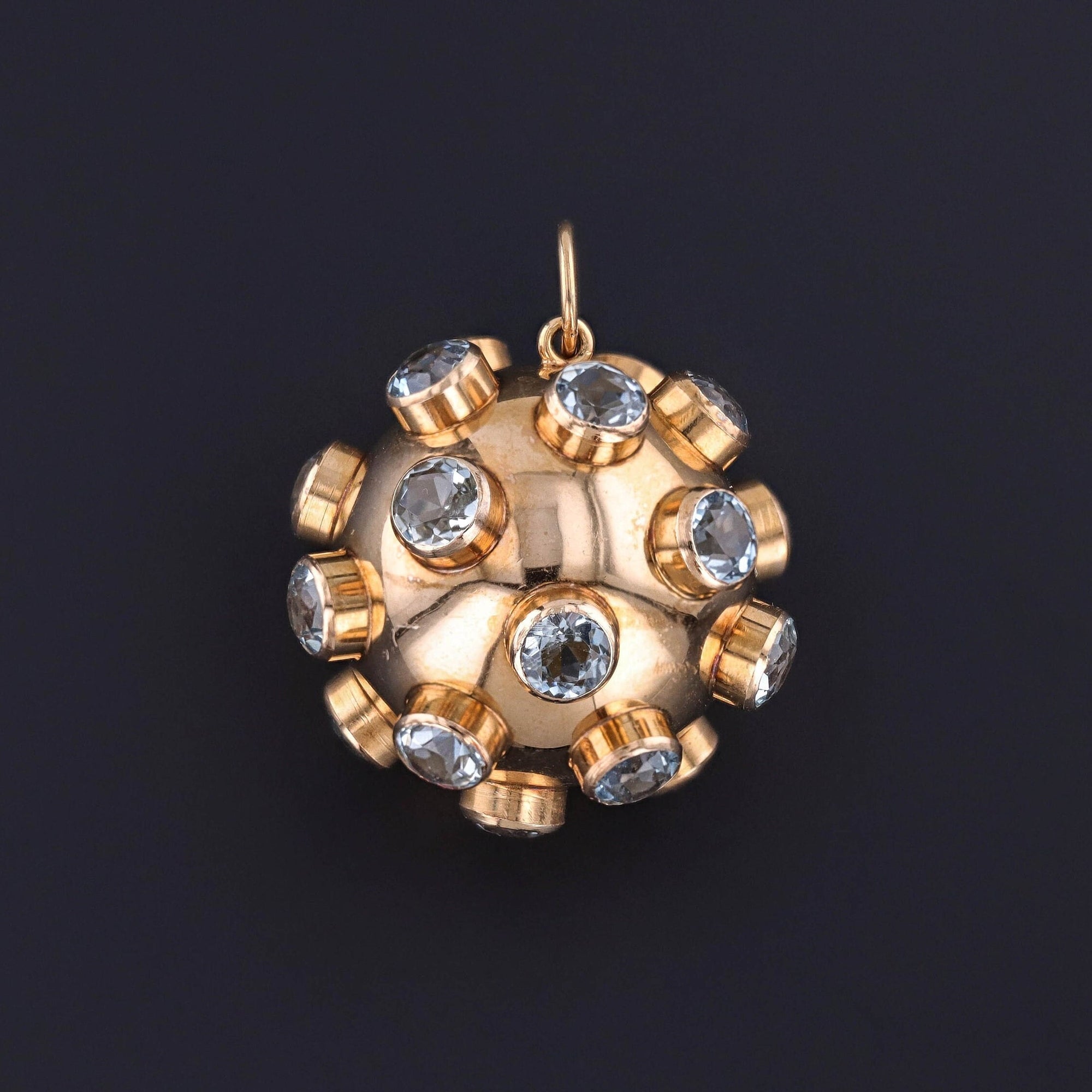 A vintage 18k gold sputnik pendant adorned with aquamarines. The substantial 18k gold piece dates to the 1960s and is a perfect gift for anyone who loves the space race or celestial items.