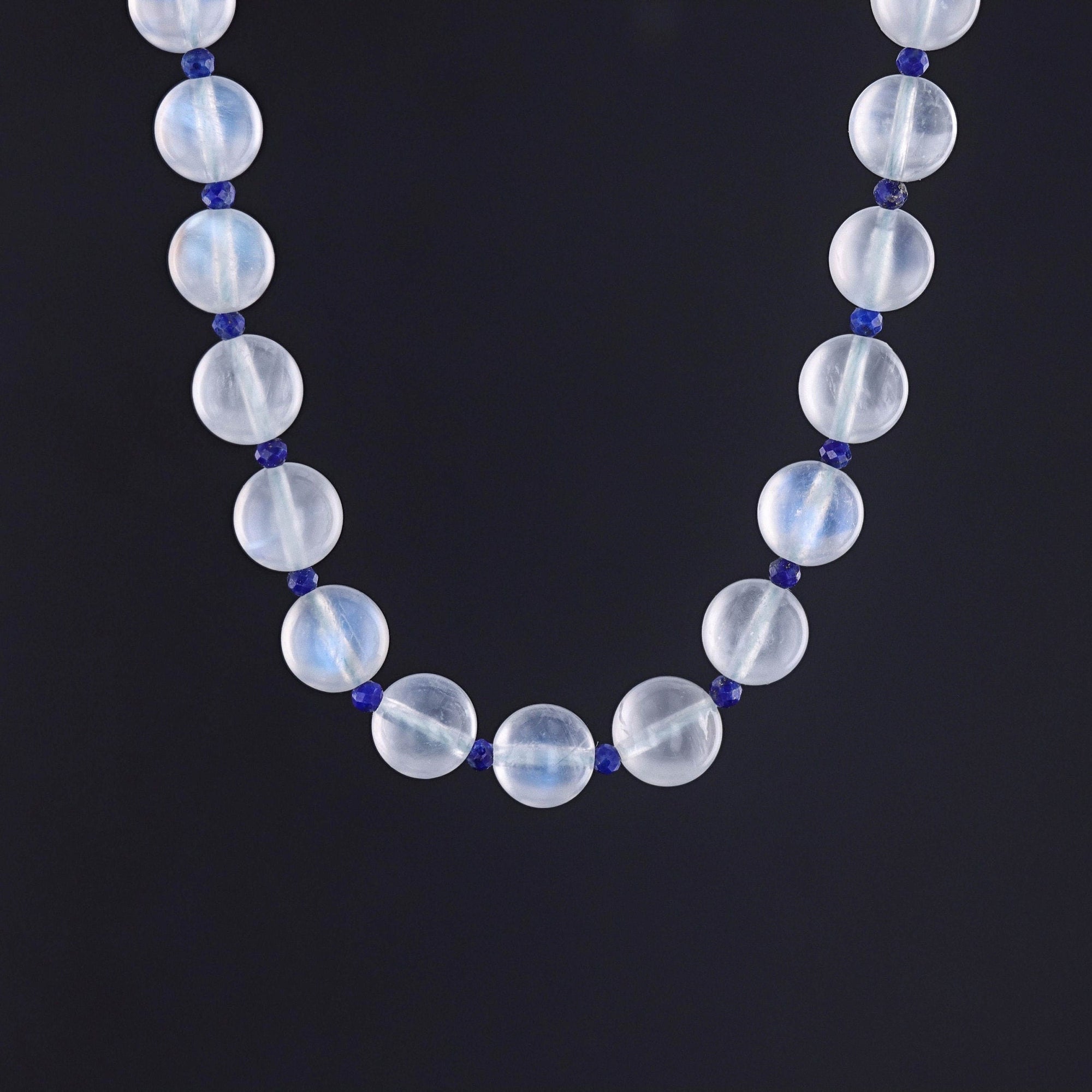 A vintage drilled moonstone and lapis bead necklace from the 1920s. The piece has a 14k white gold clasp adorned with a diamond.