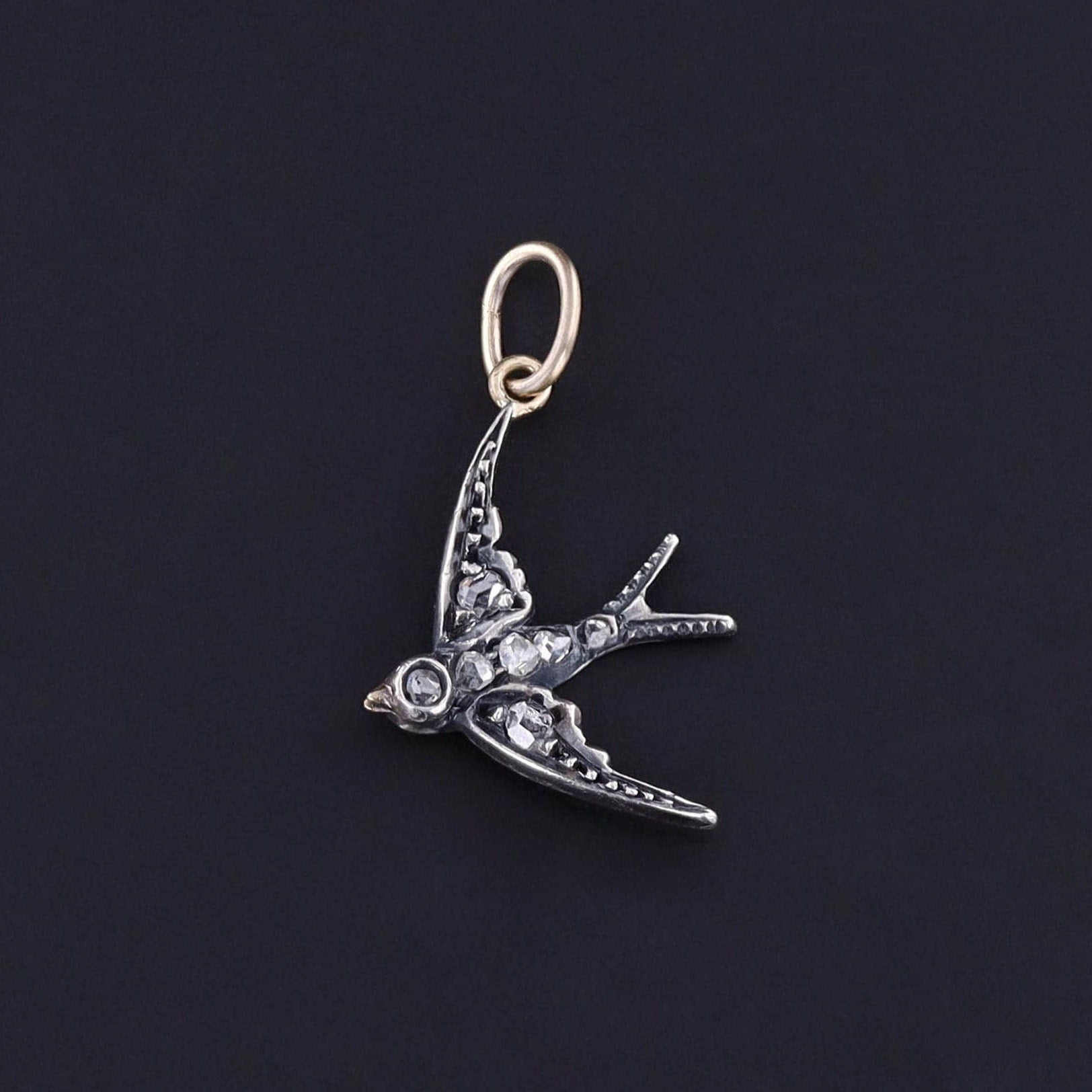 An antique diamond bird charm created from a brooch (circa 1890-1900). The piece was upcycled along with two other swallows. We turned the others into matching earrings. They are accented with rose cut diamonds.