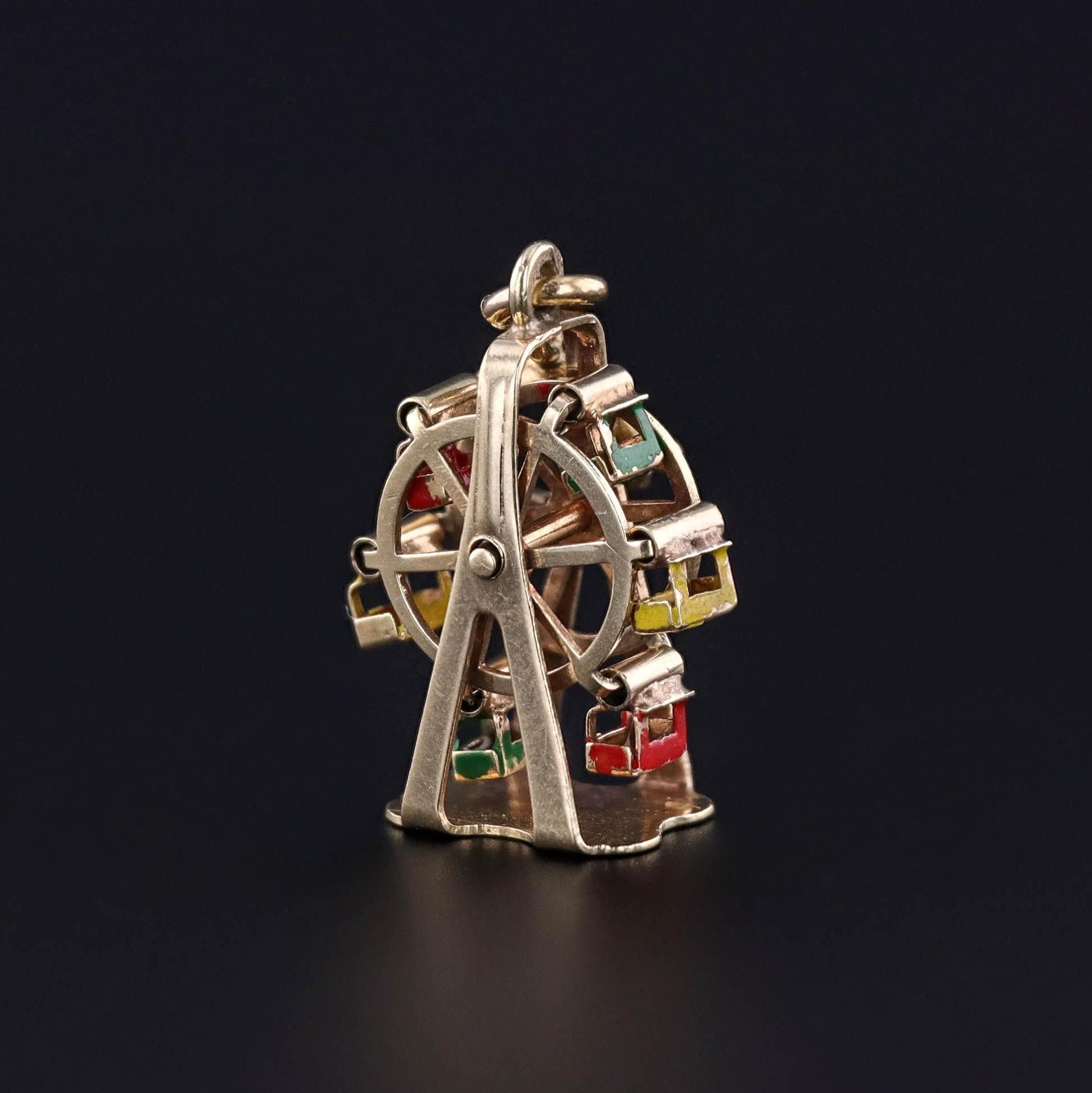 A vintage ferris wheel charm of 14k gold and enamel. The charm dates to the 1950s.