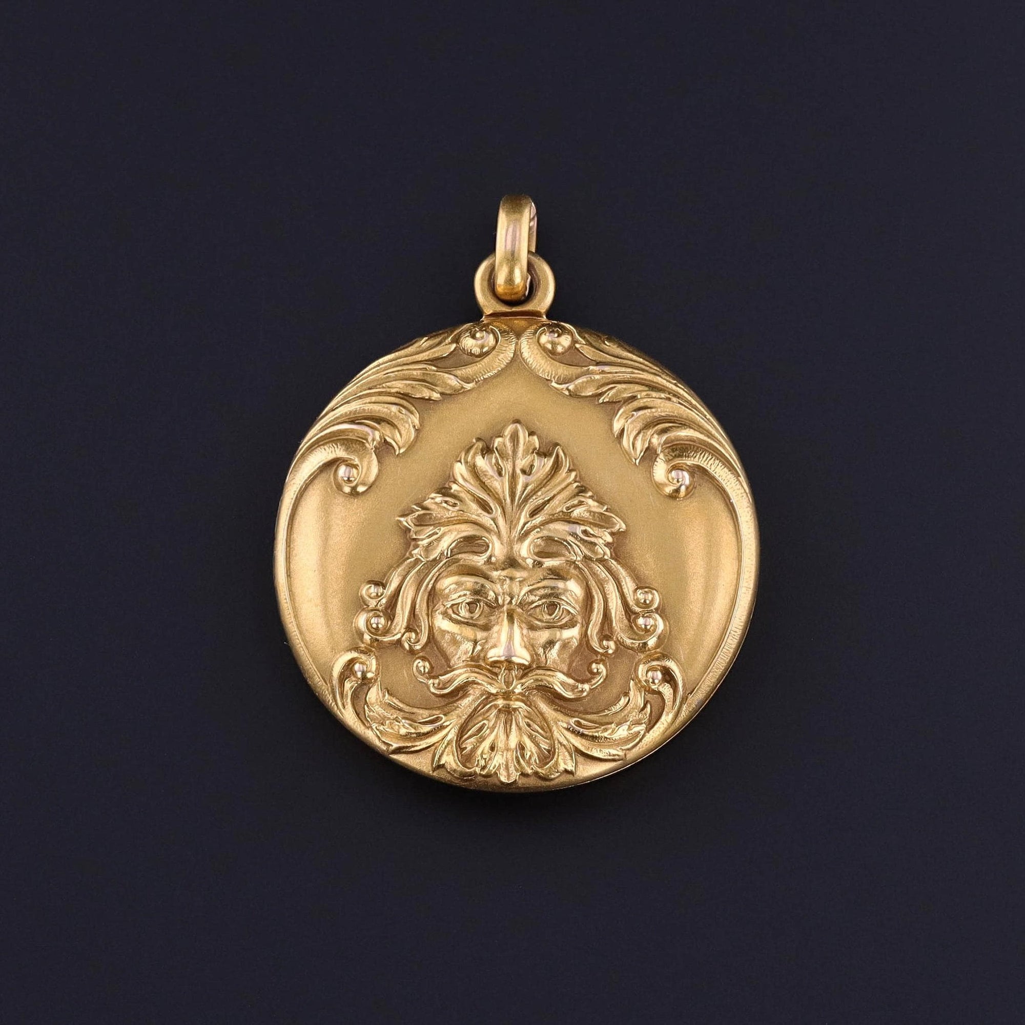 An antique green man locket from the turn of the 20th century. This locket is 14k gold with the initials JJS on the back. It is in great condition.
