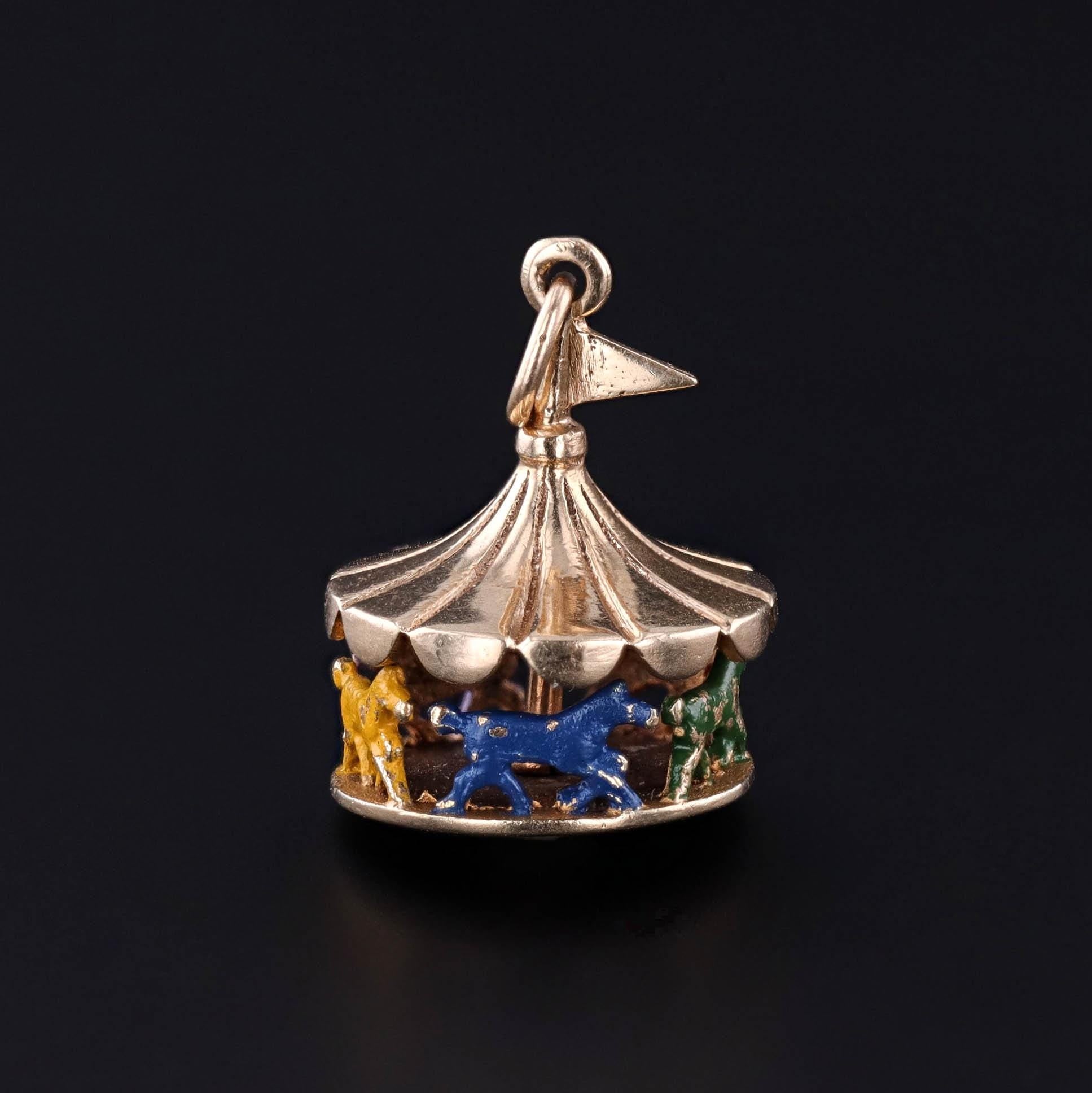 A vintage carousel charmof 14k gold adorned with colorful enamel. The mid-century jewel is in good condition with some wear to the horses. Perfect for any charm collector, amusement park lover, or vintage jewelry lover.