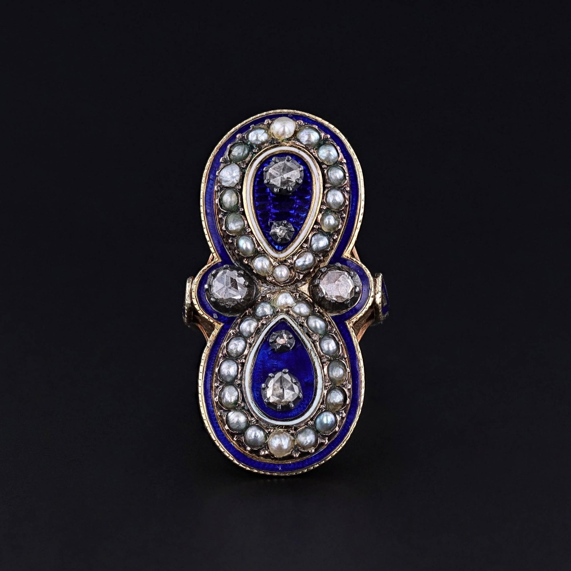 A stunning mid-Victorian era ring with vibrant blue enamel, diamonds, and pearl accents.  The 14k gold antique is in good condition.