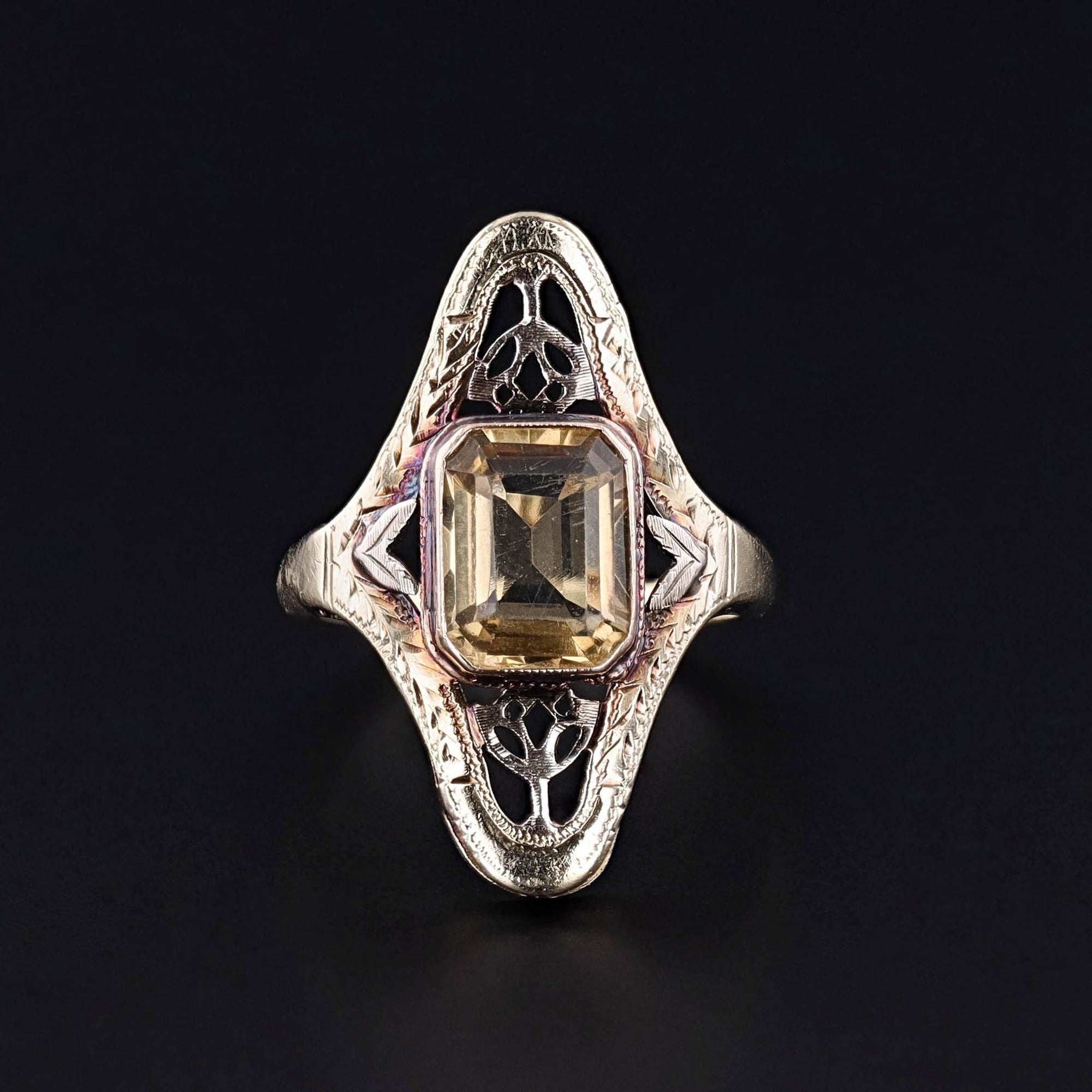 A citrine ring dating to theArt Nouveau era.It is 10k gold with hand pierced open filigree work.