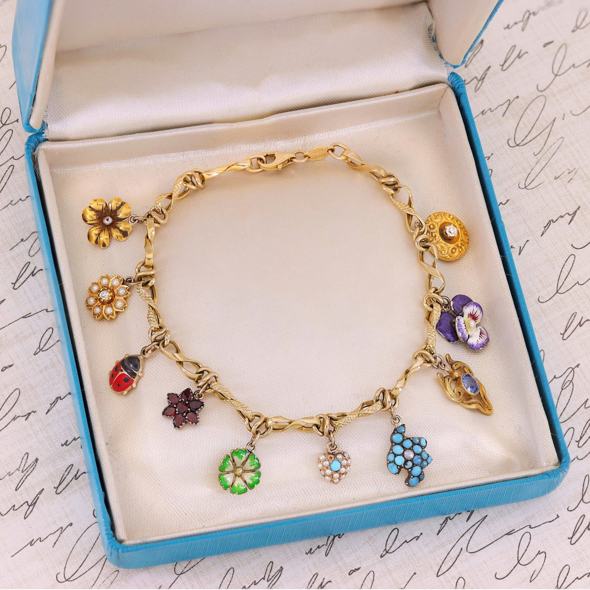 10k Gold Charm Bracelet with 10 Gemstone and Enamel Charms - Trademark Antiques