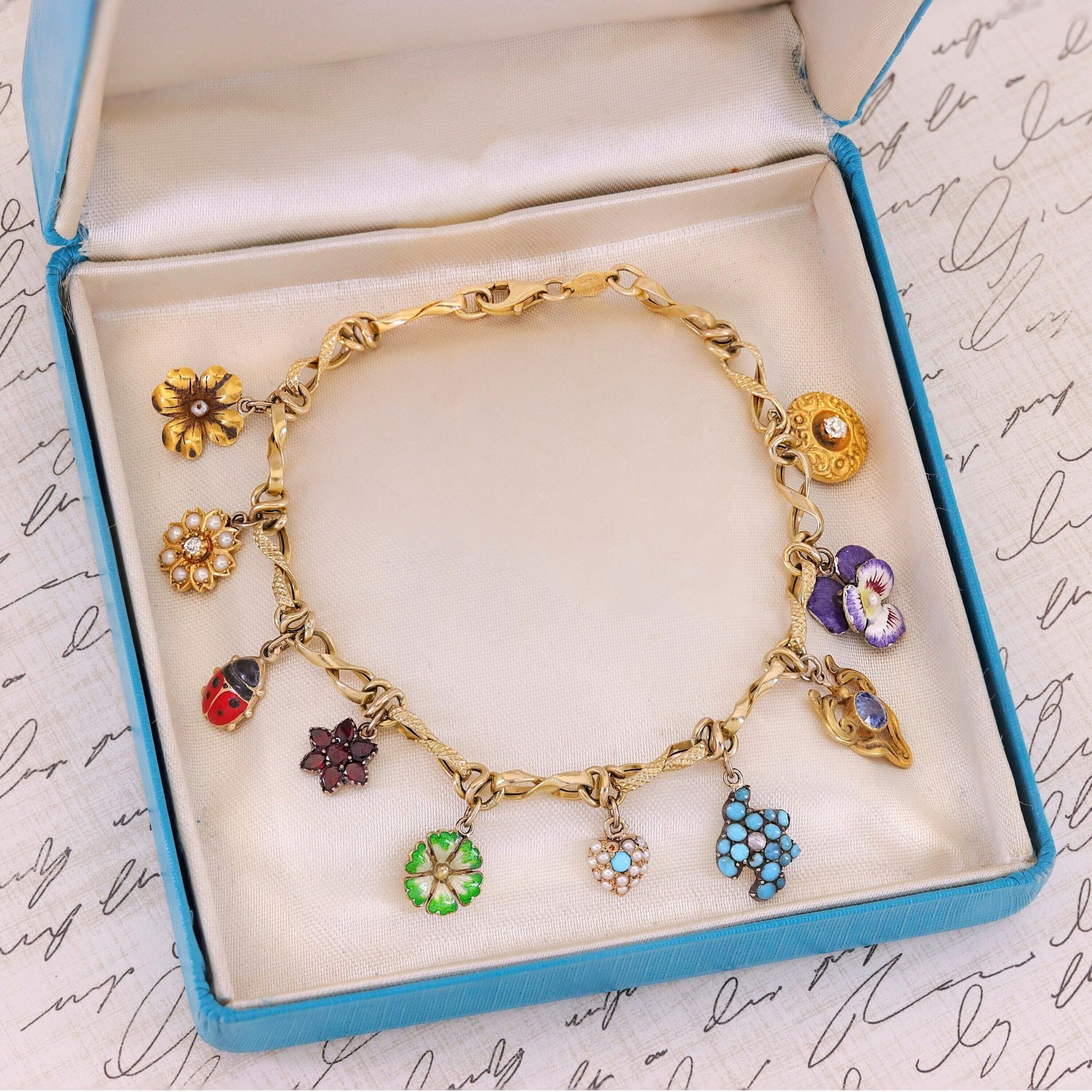 10k Gold Charm Bracelet with 10 Gemstone and Enamel Charms - Trademark Antiques